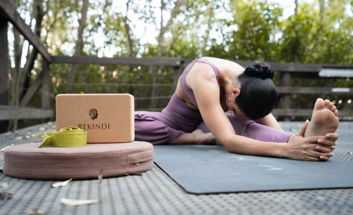 A cork yoga block set on a yoga mat, designed to provide stability, support, and comfort for various yoga poses. Perfect for enhancing flexibility, balance, and relaxation in any yoga practice.